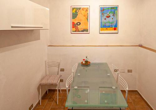 a dining room with a glass table and chairs at Casa in zona strategica in Spoleto