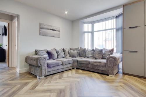 a living room with a couch and a large window at Ashley Road Apartment 2 in Poole