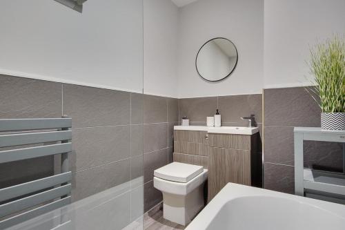 a bathroom with a toilet and a mirror at Ashley Road Apartment 2 in Poole