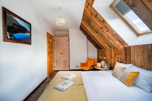 a attic bedroom with a bed and a skylight at Tarninowe Wzgórze in Kunkowa