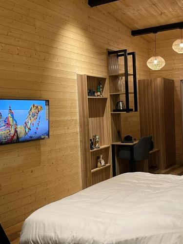 a bedroom with a bed and a tv on a wall at The Kiana's in Mussoorie