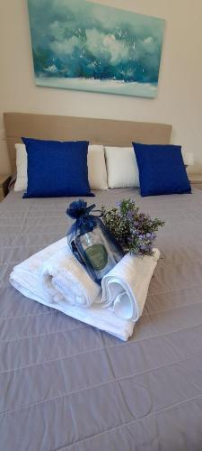 a bed with a tray of flowers on it at Sardegna Isola Rossa Casa Mirta vista mare e wifi in Isola Rossa