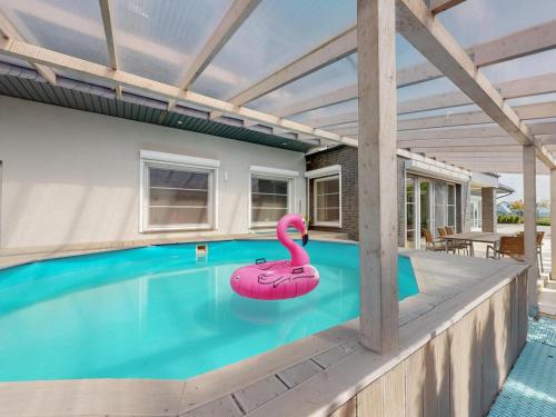a swimming pool with a pink flamingo in a house at Dom nad Morzem Pleśna78 in Pleśna