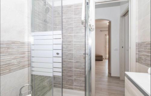 a bathroom with a glass shower and a sink at Sardegna Isola Rossa Casa Mirta vista mare e wifi in Isola Rossa