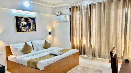 a bedroom with a bed and a large window at Aura Luxury Studio Near Golf Course Road, Sector 57, Gurgaon in Gurgaon