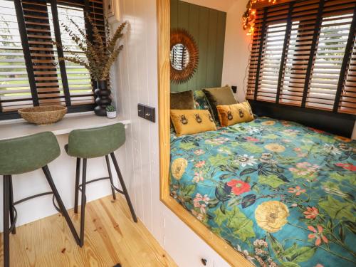 a bedroom with a bed and a mirror at Limetree Luxury Glamping Southdown in Retford