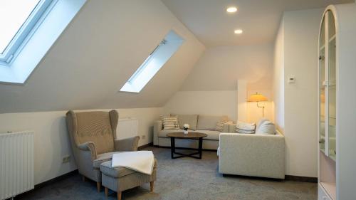 a living room with a couch and a window at Boutique Hotel Rosengarten Hamburg in Hamburg