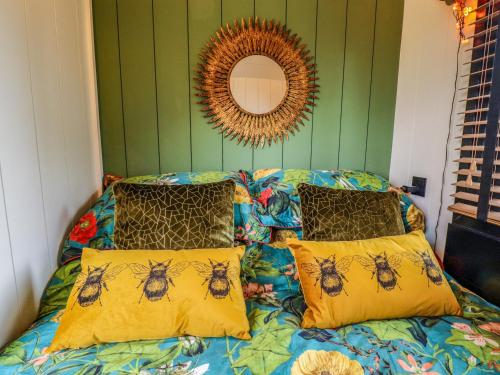a bedroom with a bed with bees on it at Herdwick in Retford
