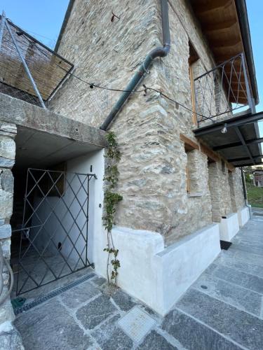 a stone building with a door and a balcony at Ca'Gialla in Bellinzona