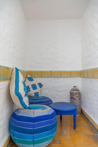 a living room with a chair and a table at Riad Al Madina in Essaouira