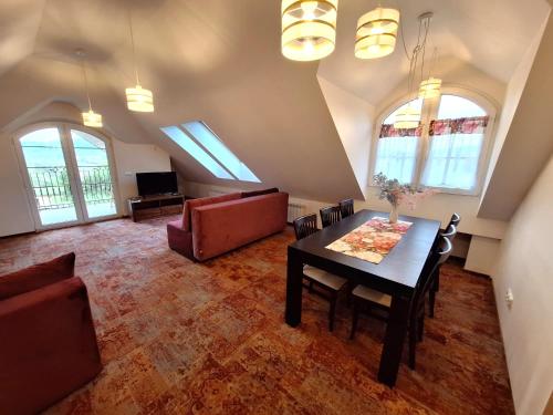 a living room with a table and a couch at Windmill Resort Agroturystyka in Mucharz