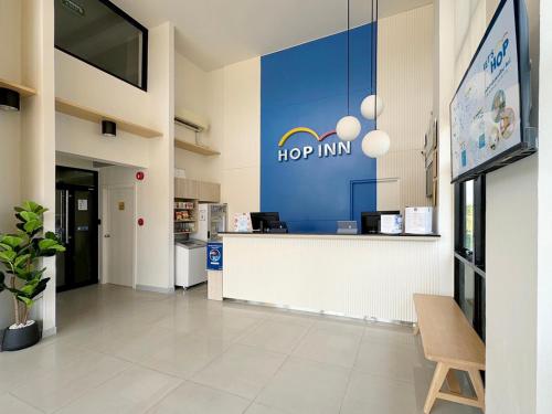 a hop inn lobby with a sign on the wall at HOP INN Kanchanaburi Building A in Kanchanaburi