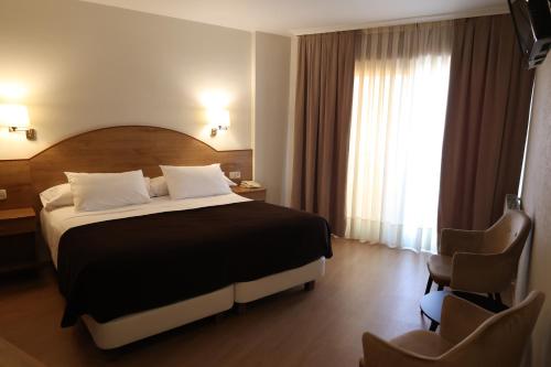 Ένα ή περισσότερα κρεβάτια σε δωμάτιο στο Hotel Maruxia *** Superior