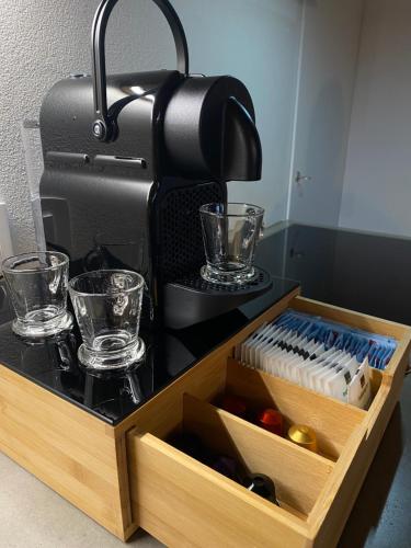 a wooden tray with glasses and a coffee maker at Ca'Gialla in Bellinzona