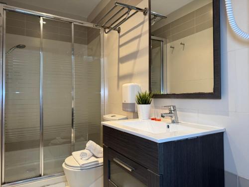 a bathroom with a sink and a shower at Wave Apartments in Villajoyosa