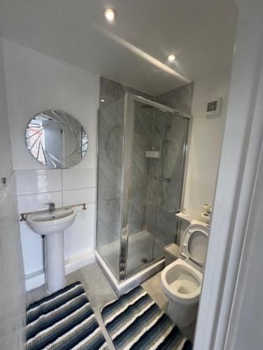 y baño con ducha, aseo y lavamanos. en Beautiful apartment in slough en Stoke Poges