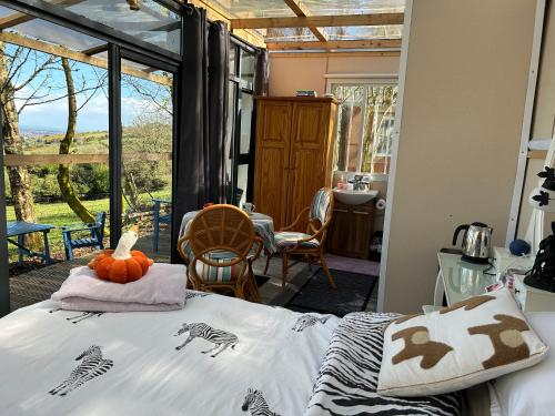 a bedroom with a bed with a view of a yard at Sky gazer cabin in the woods in Dublin