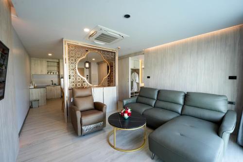 uma sala de estar com um sofá e uma mesa em โรงแรมออร่า สงขลา em Hat Yai