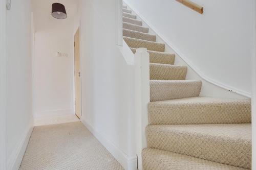 a staircase in a home with white walls at Ashley Road Apartment 3 in Poole