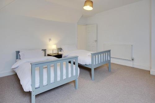 a bedroom with two twin beds and a table at Ashley Road Apartment 3 in Poole