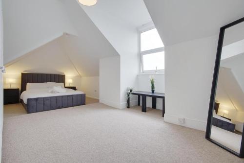 a bedroom with a bed and a mirror at Ashley Road Apartment 3 in Poole