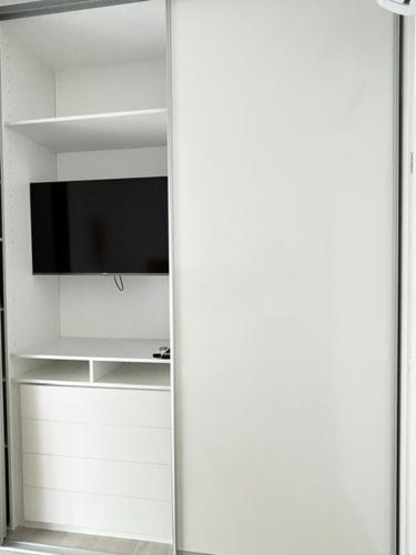 a mirror in a room with a tv on a shelf at Aurus 2 in Korčula