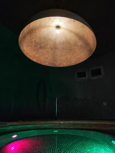 a large light hanging from the ceiling of a pool at Hotel 1622 - Spa, Hotell & Konferens in Helsingborg