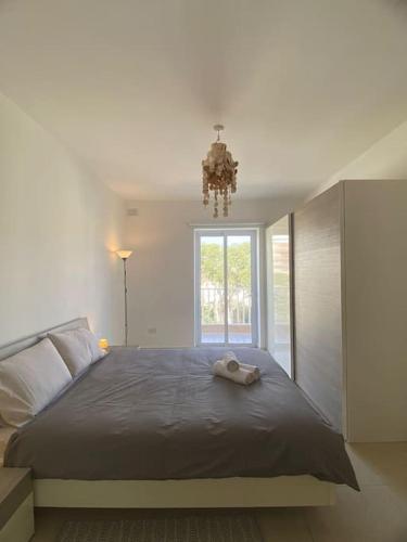 a bedroom with a large bed with a large window at Central Sliema 3bdr. Apartment in Sliema