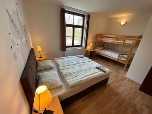 a bedroom with two bunk beds and a window at Penzion Maják in Dublovice