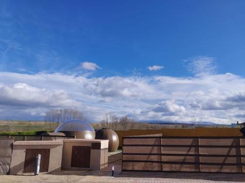 a building with two silver domes and a fence at COSMOVEROS - Hotel Burbuja in Pedraza-Segovia
