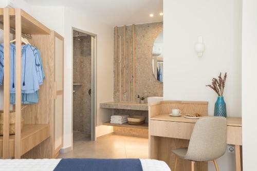 a bedroom with a bed and a desk and a mirror at Villa Iris, beachfront, with jacuzzi, up to 9 guests, Mpali beach, Rethymno! in Balíon