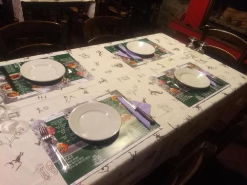 a table with plates and chopsticks on top of it at agriturismo il riccio in Cedegolo