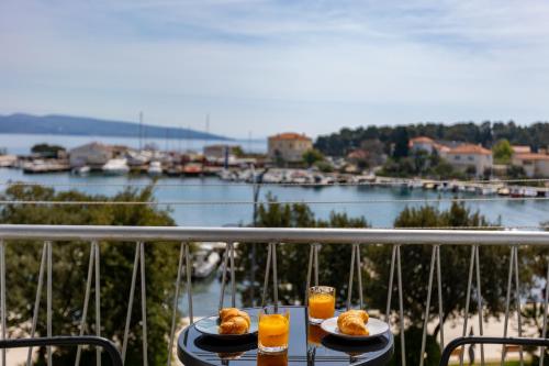 a table with two plates of food and glasses of orange juice at Apartment Marin Krk in Krk