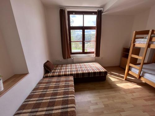 a living room with a couch and a window at Penzion Maják in Dublovice