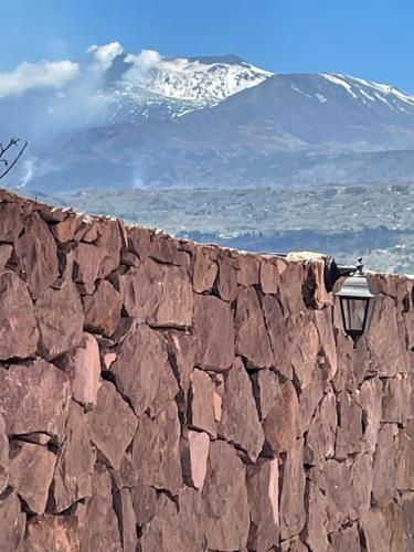 a stone wall with a light on top of it at Le Decime in Mascali