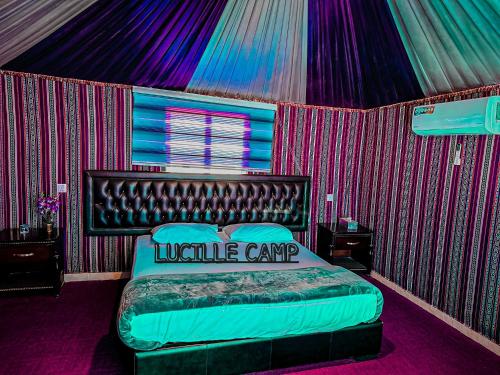 a bedroom with a large bed in a tent at Rum Lucille Luxury camp in Wadi Rum