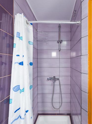 a bathroom with a shower with a shower curtain at Homy seaside studio Quiet stay near center in Ierapetra