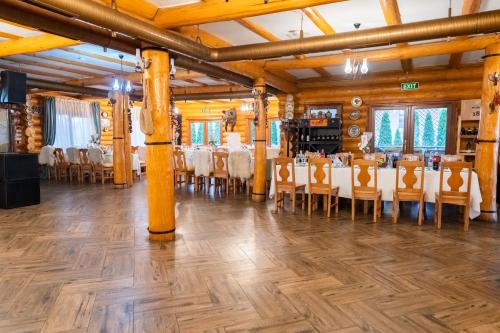 a banquet hall with tables and chairs in a room at Domeniul Haiducilor Bucovina in Suceava