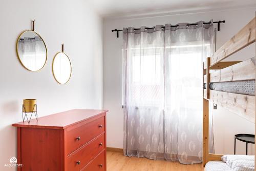 a bedroom with a dresser and a window at By Santa in Santa Cruz