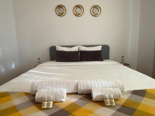 a bed with two pillows and two towels on it at Almada Central Apartment in Almada