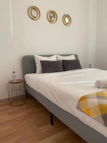 a bedroom with a bed with three plates on the wall at Almada Central Apartment in Almada