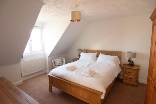a bedroom with a bed with two towels on it at Bilbo's Cottage, Sheringham in Sheringham