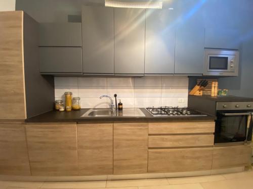 a kitchen with a sink and a stove at Villa Medusa in Tre Fontane