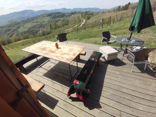 a table and chairs on a deck with a view at Brvnare Kušići in Ivanjica