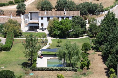 an aerial view of a house with a swimming pool and trees at Quinta Fronteira in Bensafrim