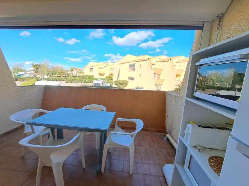 - un petit balcon avec une table et des chaises bleues dans l'établissement Studio cosy 4 pers avec terrasse, parking sécurisé, proche commerces à Marseillan - FR-1-326-591, à Marseillan