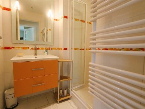 a bathroom with a sink and a shower with a mirror at Bénodet, appart. 3*, plage à pied, parking privé - FR-1-481-52 in Bénodet