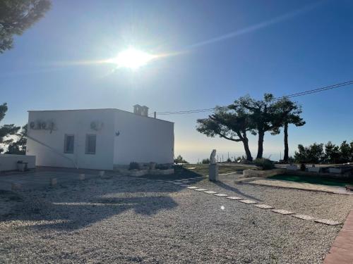 a white house with the sun in the sky at Casa Rosa in Mattinata