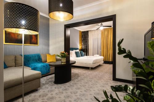 a living room with a couch and a mirror at Hotel Iskierka Business & Spa in Mielec