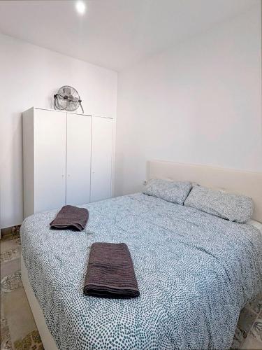 a bedroom with a bed with two towels on it at Gran Teatro Falla in Cádiz